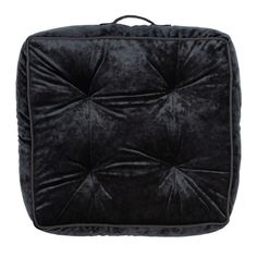 the black square cushion is made out of velvet