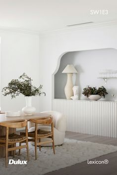 a dining room with white walls and furniture