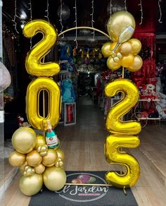 the entrance to a store decorated with balloons and streamers for new year's eve