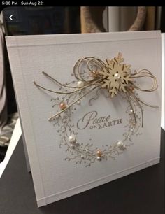 a white card with a gold snowflake on it