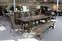 a dining room table and bench in a store