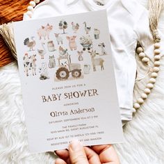 a person holding up a baby shower card