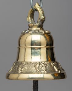 a large metal bell hanging from the ceiling