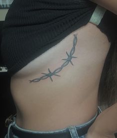 barbed wire tattoo around the side of the breast Spine Tattoos Barbed Wire, Longhorn Barbed Wire Tattoo, Barbed Wire Rib Tattoo, Tattoo Ideas Female Behind Elbow, Barbed Wire Hip Tattoo, Fine Line Barbed Wire Tattoo, Western Barbed Wire Tattoo, Bard Wire Tattoos, Barb Wire Collar Bone Tattoo