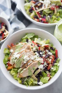 two white bowls filled with salad and dressing