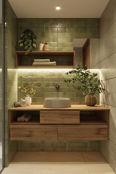 a bathroom with green tiled walls and flooring, including a wooden sink countertop