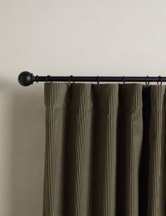 a black and white striped curtain hanging from a metal rod