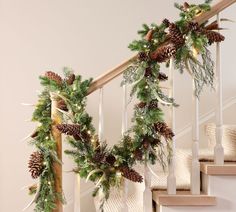 christmas garland on banisters with pine cones and greenery