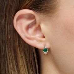 An ideal choice for mixing and matching, these huggie earrings showcase beautiful octagonal cut emeralds accented by a pair of sparkling princess cut diamonds with step cut faceting. These modern day heirlooms are comfortable and lightweight so that they can be worn and enjoyed with ease. Metal: 18kt Gold Emerald Weight: 1.00 ct. Diamond Weight: 0.39 ct. Measurements: 15.0 mm length *Please note that the listed ct. weights are approximate and may be subject to slight variations. Elegant May Birthstone Huggie Earrings For Anniversary, Elegant May Birthstone Gemstone Huggie Earrings, Octagon Emerald Jewelry With Brilliant Cut, Elegant Emerald Huggie Earrings As Gift, Elegant Emerald Huggie Earrings For May Birthstone, Luxury Green Huggie Earrings Fine Jewelry, Emerald-cut Emerald Diamond Earrings, Octagon Emerald Gemstone Jewelry, Fine Jewelry Emerald In Octagon Shape