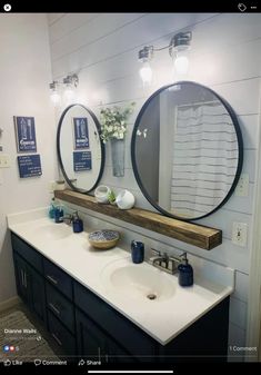 a bathroom with two round mirrors on the wall