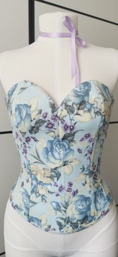 A beautiful floral blue cotton corset is a versatile thing, it can be very cool to combine with other things, like jeans, skirts, shorts, etc. Top is cotton, lining is bemberg, lacing on the back Size M Fits Bust: 33 - 34.5 inches Waist: 25.5 - 26 inches Hip: 35 - 36 inches Please feel free to contact us if you are not sure which size to choose. Cheap Blue Spring Corset, Luxury Blue Summer Corset, Floral Print Fitted Corset, Fitted Floral Print Corset Dress, Fitted Overbust Spring Corset, Summer Floral Print Corset With Fitted Bodice, Feminine Underbust Corset For Spring, Strapless Floral Print Corset For Spring, Strapless Floral Corset For Spring