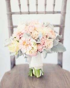 a bouquet of flowers sitting on top of a wooden chair