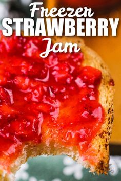 a piece of bread with strawberry jam on it and the words freezer strawberry jam