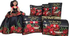 the doll is wearing a black dress with red roses on it's skirt and matching pillows