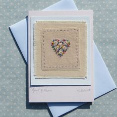 two greeting cards with an embroidered heart on them