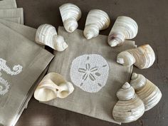 seashells on linen placemats and napkins with embroidered sand dollar symbol