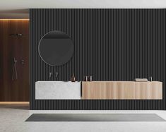 a modern bathroom with black and white stripes on the wall, round mirror above the sink