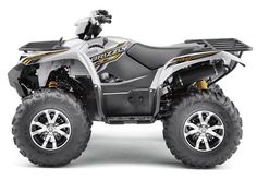 a four - wheeler is shown in front of a white background with black wheels and tires