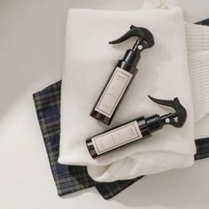 two bottles of wine sitting on top of a white cloth next to a pair of scissors