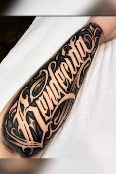 a man's arm with the word tattoo on it