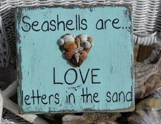 a sign that says seashells are love letters in the sand