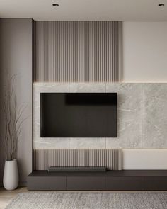 modern living room with white and grey walls, large flat screen tv on the wall