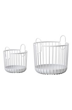 two white wire baskets sitting next to each other