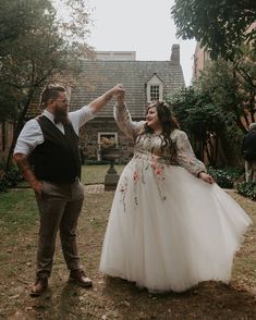 a man standing next to a woman in a white dress