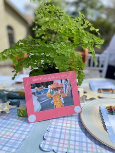 a table set up with plates and place settings for a child's birthday party