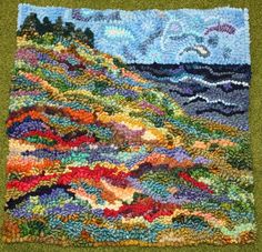 a patchwork quilt with an ocean scene on the side and clouds in the sky