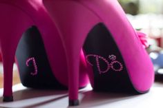 a pair of pink high heeled shoes with bling on them