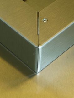 a metal object sitting on top of a wooden table