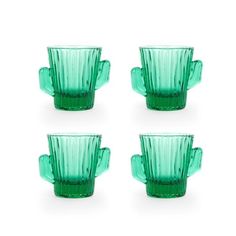 four green glass cups sitting next to each other