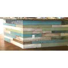 an old wooden bar is made out of pallets and wood planks with blue paint on the top