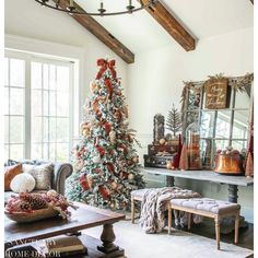 a living room with a christmas tree in the corner and other decorations on the table