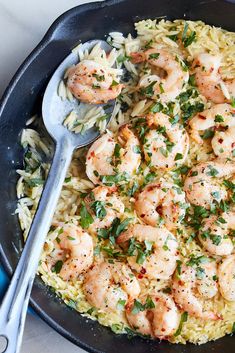 a skillet filled with shrimp and rice