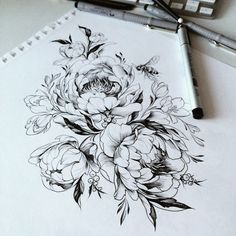 an image of flowers drawn on paper next to a pen