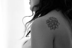 a woman with a flower tattoo on her shoulder