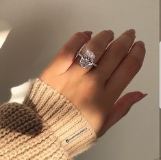 a woman's hand with a ring on it