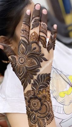 a woman with henna on her hand