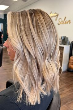 Medium-length layered cut with soft waves, featuring a blend of honey blonde and ash highlights that create a dimensional and vibrant look. The subtle layers add movement and volume, perfect for a fresh and modern style.  // Photo Credit: Instagram @hellobalayage Light Brown Balayage Blonde Highlights, Blonde Bayalage For Fall, Medium Length Highlighted Hair Blonde, Medium Length Hair With Blonde Balayage, Blonde Balayage With Dark Lowlights, Dimensional Blonde Long Bob, Blonde With Natural Lowlights, Partial Highlight Blonde Hair, Long Blonde Hair With Layers Highlights