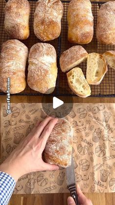 there are many different types of breads on the rack and one is being sliced