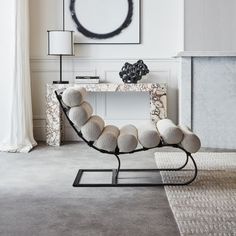 a chair with balls on it sitting in front of a mirror and lamp next to a fireplace