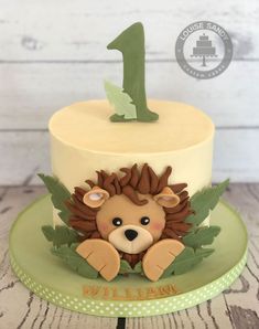 a birthday cake with a lion on top and the number one on it's side