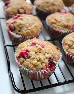 muffins cooling on a wire rack with fresh fruit