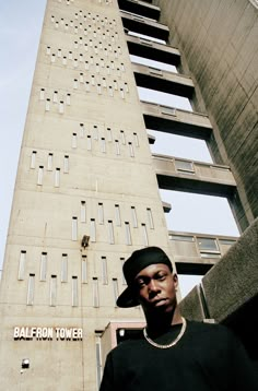 a man standing in front of a tall building