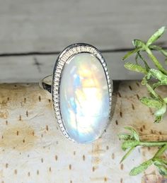 "Natural Premium AAAA Grade Oval Rainbow Moonstone .925 Sterling Silver Ring Size 7.5 9.8 Grams 1\" x 11/16\" GJ29. Lots of blue and orange color flash! We are known for our high quality and also larger size Rainbow Moonstone. Large Rainbow Moonstone of the highest quality is very hard to find and is expensive when you do. This is a handpicked natural stone, the exact one shown in picture.  The sterling silver is .925 and stamped.  Each piece is hand made by artisans in my shop.  The quality of the stones and the silver workmanship is impressive. Please look at other items in my store.  I sell ready made jewelry with hand crafted silver work, pendants with a sterling silver bails and beautiful unique cabochons for jewelry wire wrapping and weaving. You will pay exact amount on shipping plu Sterling Silver Moonstone Ring, Moonstone Ring Sterling Silver, Ring Moonstone, Hippy Gifts, Rainbow Moonstone Ring, Silver Work, Ring Boho, Boho Ring, Moonstone Ring