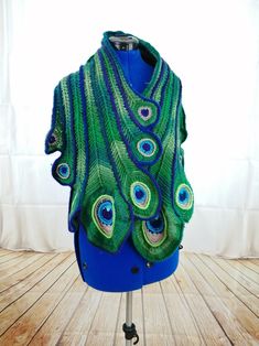 a blue and green shawl with peacock feathers on it