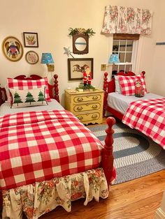 two beds in a bedroom with red and white checkered covers