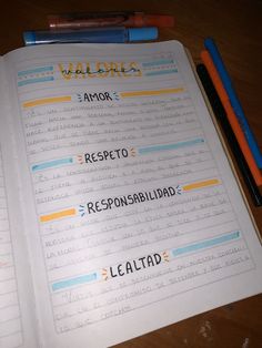 an open notebook with spanish words on it and two pencils next to the pages